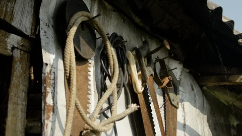Various working tools on the wall of the village house Stock Footage 121489092