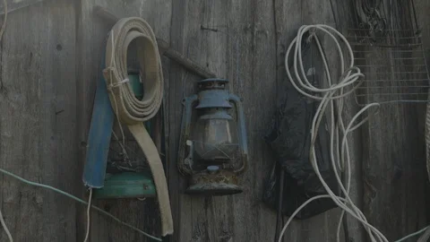 Various working tools on the wall of the village house Stock Footage 121492166