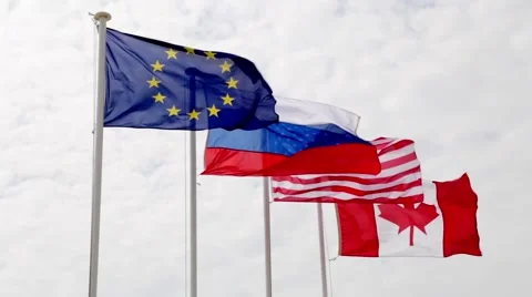 Various world flags flying on flagpoles in a cloudy sky Stock Footage 61566531