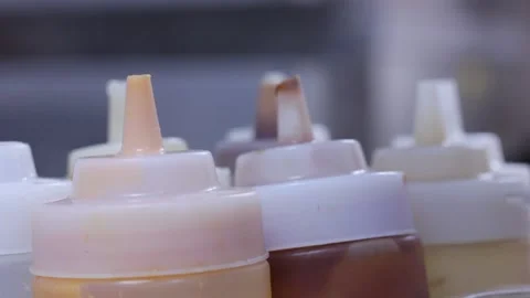 Varity of sause bottles at the kitchen table Stock Footage 146656149
