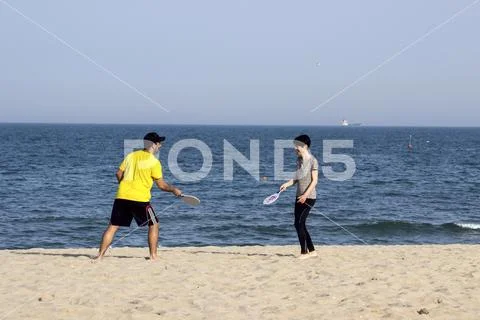 Varna Bulgaria 13 May 2017 man and woman play ball on the beach Stock Photos