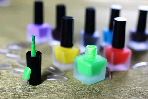 Varnish manicure false nails a small set of detail for manicure on a gold ... Stock Photos