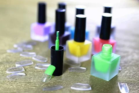 Varnish manicure false nails a small set of detail for manicure on a gold ... Stock Photos