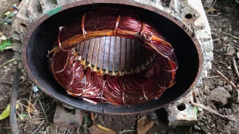 Varnished Copper Stator Winding in Open Electric Motor Casing Lying on Dirt Grou Stock-Footage 344792533