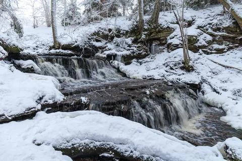 Vasaristi tiny cascade in winter, Lahemaa national park, Estonia. Long exposu Stock Photos