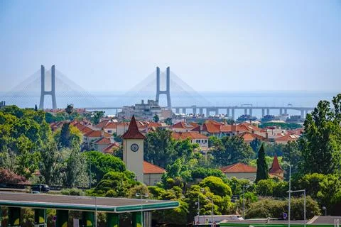 Vasco da Gama Bridge beyond Lisbon rooftops by the Tagus River on clear sunny 스톡 사진