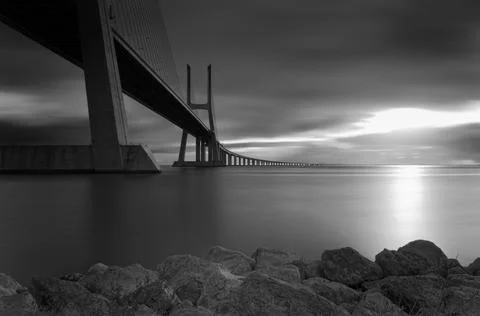 Vasco da Gama concrete bridge riverscape during a cloudy sunrise Stock Photos