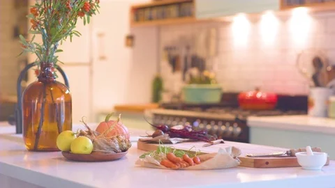 Vase and fresh vegetables kept on kitchen worktop Stock Footage 76138918