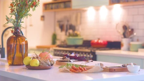 Vase and fresh vegetables on kitchen worktop Stock Footage 76138911