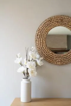 Vase of artificial flowers on side table in living room Stock Photos
