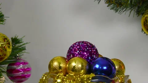 Vase with balls between burning candles with Christmas wreath and fir tree Stock Footage 201015163