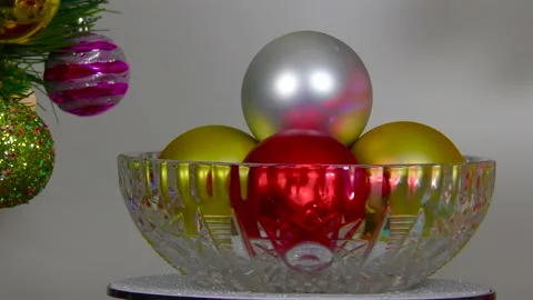 Vase with balls between a gift on the background of a Christmas wreath Stock Footage 201015365