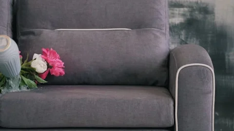A vase of flowers fell on the sofa Stock Footage 160938606