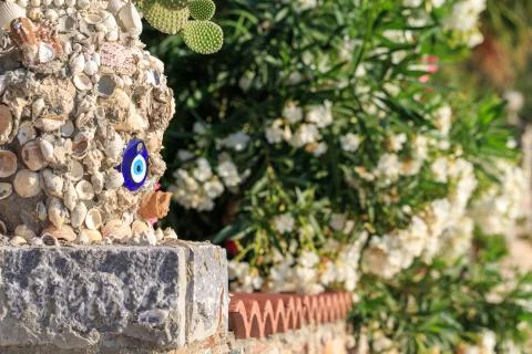Vase with seashell and evil eye on the wall in Turkey Stock Photos