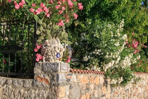 Vase with seashell and evil eye on the wall in Turkey Stock Photos