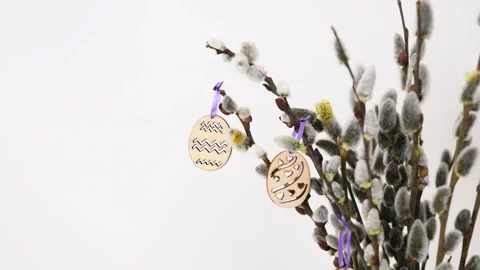 Vase with tree branches and Easter eggs on dining table in light kitchen. 動画素材 331720522