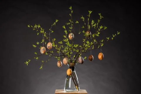 Vase with tree branches and multicolored hand painted easter eggs Stock Photos