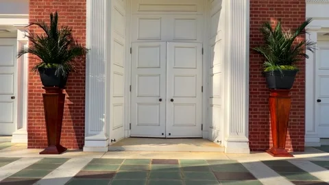Vases of palm tree branches on the sides of church entry doors on Palm Sunday Video stock 337568088