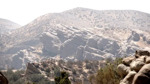 Vasquez Rocks 4K distant hazy rocks ease out V24283 Stock Footage 94737885