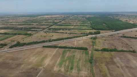 Vast agricultural fields and distant forests under a clear sky, aerial view Stock Footage 283007210