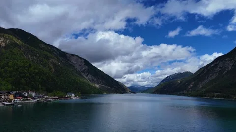 Vast Alpine Lake Basin Surrounded by Green Hills and Sky Stock Footage 342024808