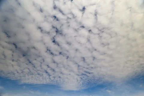 A Vast and Endless Sky Adorned with Soft, Fluffy Clouds in Various Beautiful Sha Stockfoto's