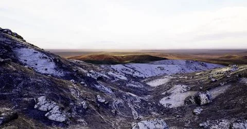 Vast and rugged landscape under soft morning light in remote wilderness Stock Illustration