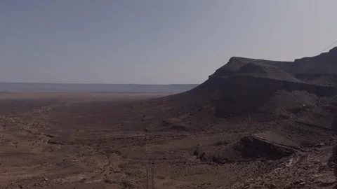 Vast arid desert plain with rocky cliff edge in Morocco Stock Footage 337195597