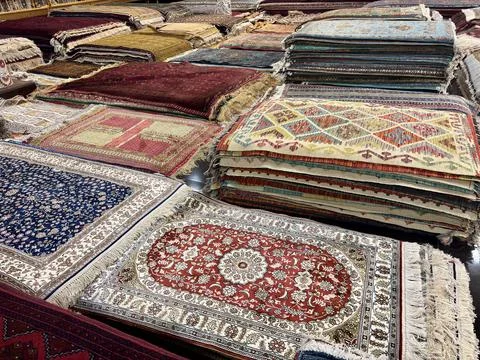 Vast array of colorful, patterned Central Asian carpets on display Stock Photos