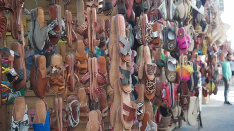 Vast Array of Handmade Sandals Displayed in a Bustling Moroccan Market Stock Footage 273485672