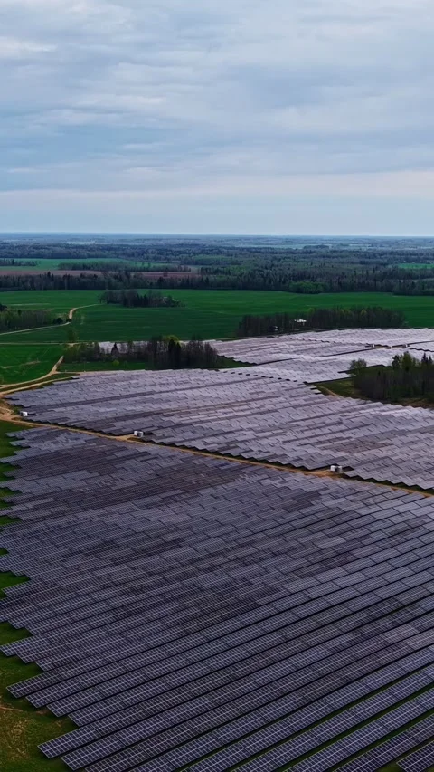 Vast Array of Solar Panels Under a Cloudy Sky in Open Countryside Stock Footage 334971118