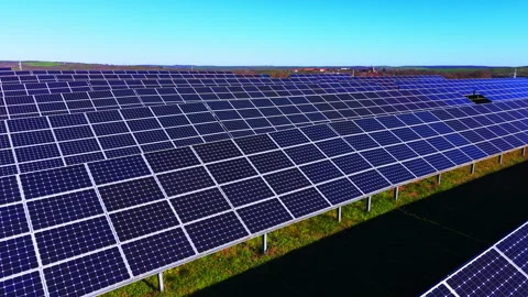 Vast array of sun tracking solar panels under blue sky, Bulgaria Stock Footage 336341681