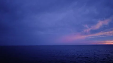 Vast blue ocean under a dramatic twilight sky with subtle hints of sunset colors Stock Footage 317326541