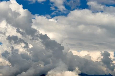 The vast blue sky background with white clouds closeup. Cloudscape. Sunny day Stock Photos