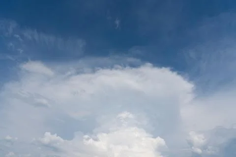 Vast blue sky with soft, wispy clouds above Stock Photos