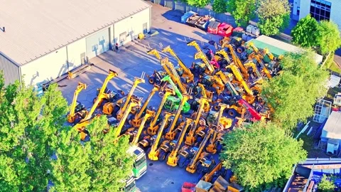 Vast collection of yellow construction machinery gathered in a sunlit outdoor Stock Footage 315686387