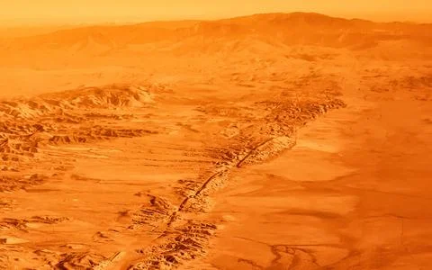 Vast desert landscape with dramatic mountain range and arid terrain Stock Photos
