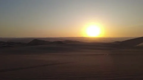 Vast desert landscape at sunset with rolling sand dunes and distant hazy mo.. Stock Footage 327756215