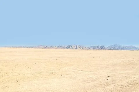 Vast Desert Plain With Distant Mountain Range Stock Photos
