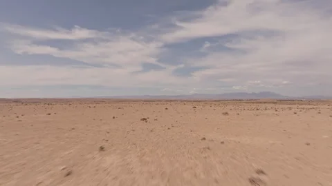Vast desolate landscape under a clear blue sky Stock Footage 292829607