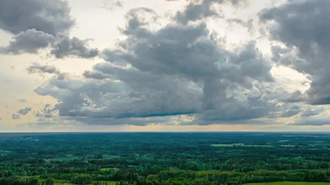 Vast Dramatic Cloudscape Over Green Landscape in Aerial Hyperlapse View Stock Footage 315550146