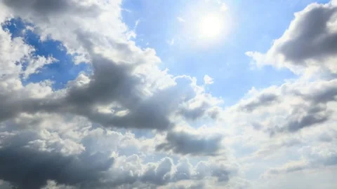 The vast expanse of blue sky was filled with thick white and grey clouds th.. Stock Footage 338390106