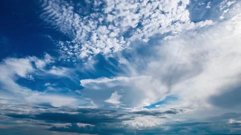 Vast expanse of dramatic white clouds drifting across a deep blue sky Vídeos de archivo 341950391