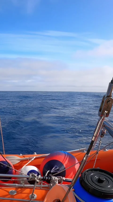 The Vast Expanse of the Open Ocean Beneath a Clear Blue Sky is Serene and Calm Stock Footage 276238287