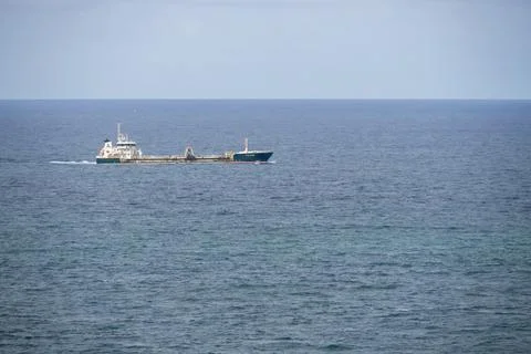 Vast expanses of ocean where a single cargo ship sails alone. Pointe du Raz, 10 Stock Photos