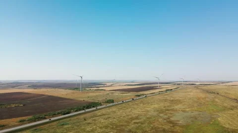 A Vast Expansive Landscape Featuring Wind Turbines Under a Bright and Clear Blue Stock Footage 305901337