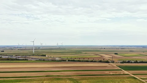 Vast fields with wind turbines in view during a cloudy day in the countryside Stock Footage 342786127