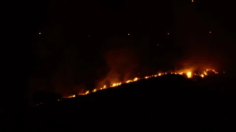 Vast fire devours hill in the night Stock Footage 278969424