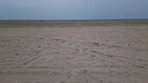Vast Flat Sandy Beach with Tire Tracks and Sea Horizon near Ribe, Denmark Stock Footage 333897434