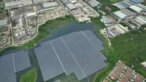 Vast Floating Solar Farm Installation Over Water Near Industrial Complex Stockbeeldmateriaal 337330761